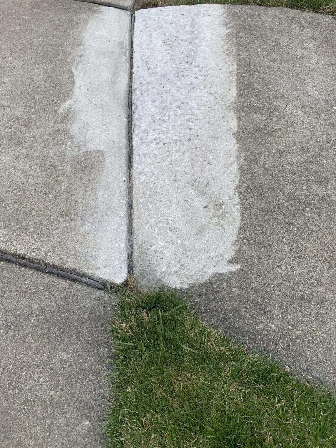 Freshly cleaned concrete sidewalk section