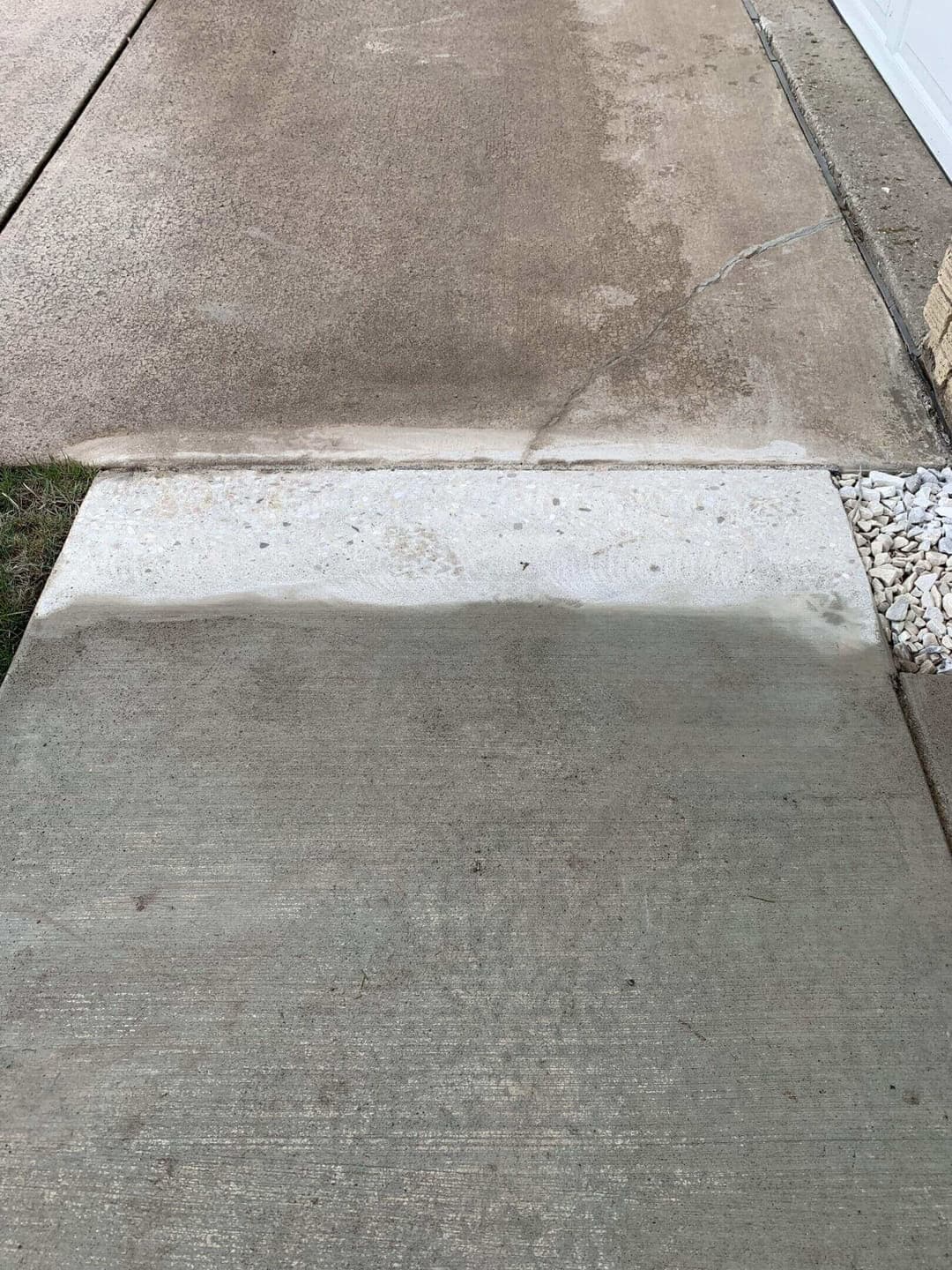 Concrete driveway with a visible cleaning line