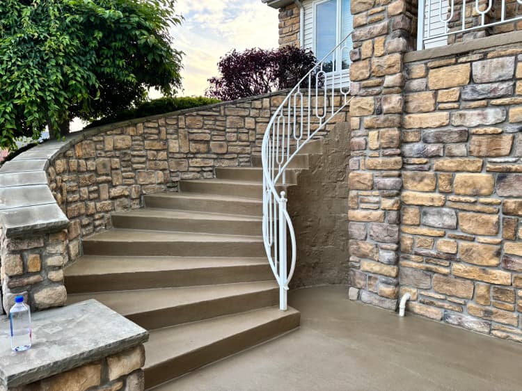 Resurfaced concrete steps with stone retaining wall in Western New York