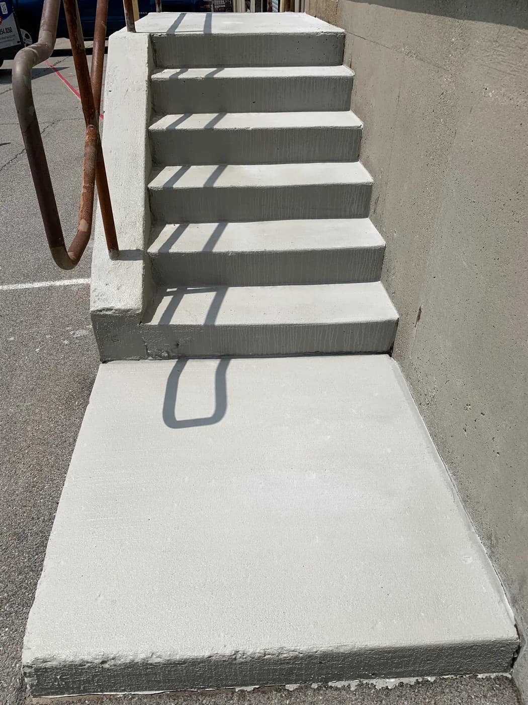 Commercial concrete stair landing after resurfacing and edge repair near Buffalo NY