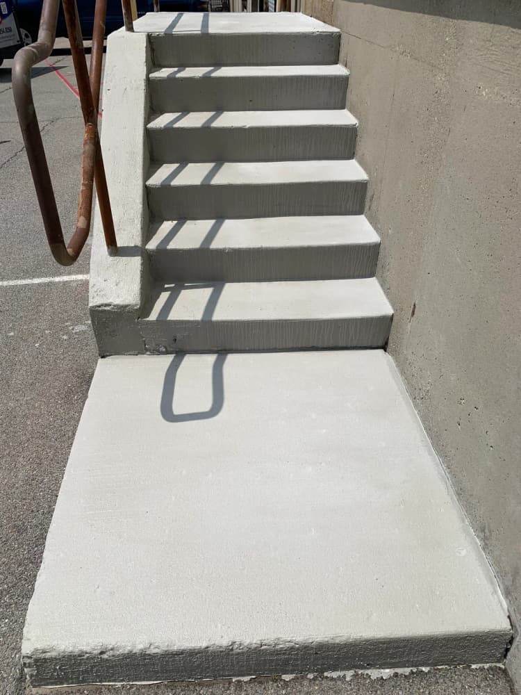 Commercial concrete stair landing after resurfacing and edge repair near Buffalo NY